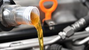 Engine oil being poured into a car