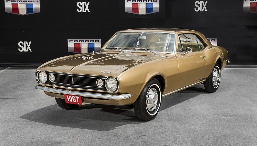 The very first Camaro produced sits on display in an illuminated glass case