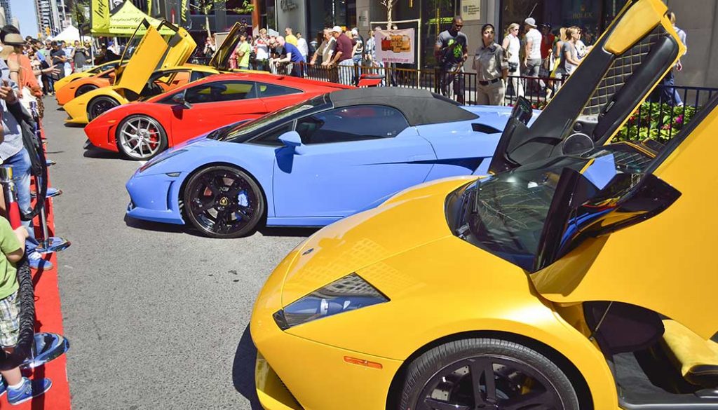 A row of mid-engine supercars lined up at a car show