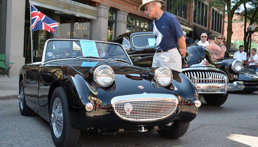 An admirer inspects a tiny Austin Healy Sprite