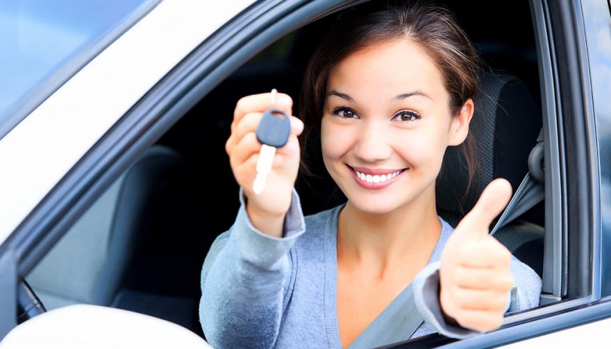 A woman holds the keys to what may be her first used car