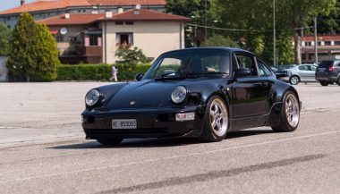 An air-cooled 911 driving down the road.