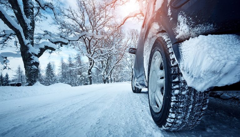 Car driving on snow shows why it is important to winterize your car