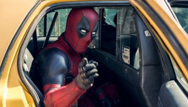 Deadpool getting out of his movei car, a taxi