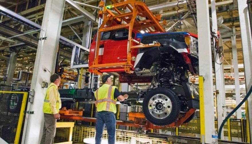 An employee works on a Ford plant assembly line.