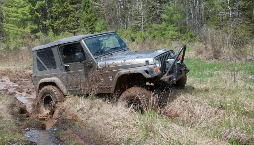 A Jeep Wrangler tearing through a rut shows how it is a dependable off-road vehicle