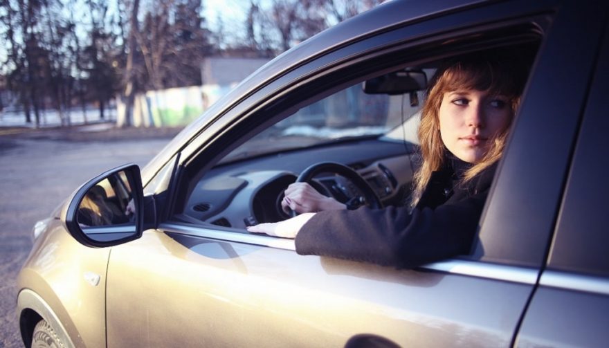 Driving tips for beginners like this young woman include staying calm