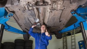 A mechanic performs car modifications