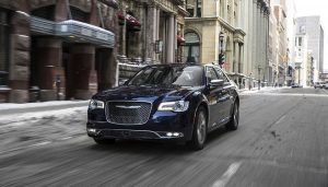 A 2017 Chrysler 300 drives down a street