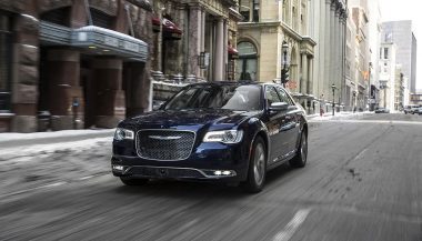 A 2017 Chrysler 300 drives down a street