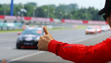 A performance driving instructors gives a thumbs up