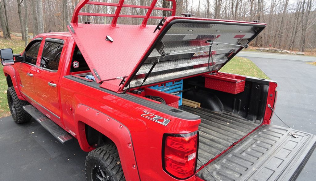 A red truck, sporting various truck accessories.