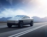 A Tesla Cybertruck riding on the road on a sunny day.